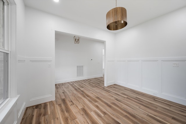 1065 Cedar Fox Ct, Forest, VA 24551 - empty room with wainscoting, a decorative wall, visible vents, and wood finished floors