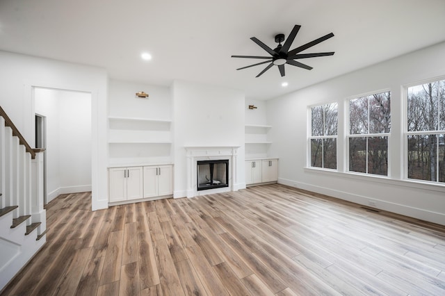1065 Cedar Fox Ct, Forest, VA 24551 - unfurnished living room featuring stairway, ceiling fan, a fireplace, and baseboards
