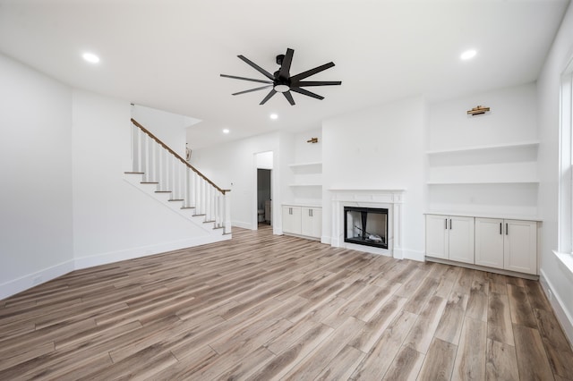 1065 Cedar Fox Ct, Forest, VA 24551 - unfurnished living room featuring recessed lighting, ceiling fan, stairway, a fireplace, and light wood-type flooring