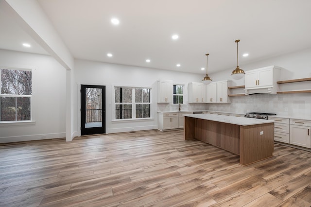 1065 Cedar Fox Ct, Forest, VA 24551 - kitchen with white cabinetry, open shelves, a kitchen island, light countertops, and tasteful backsplash