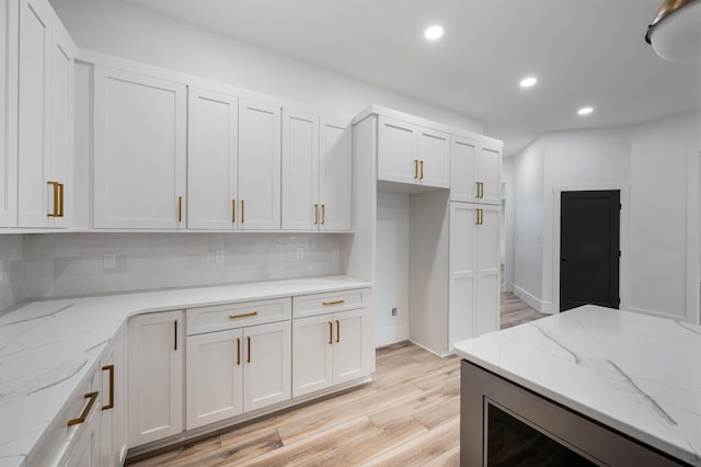 1065 Cedar Fox Ct, Forest, VA 24551 - kitchen featuring light wood-style flooring, white cabinetry, light stone countertops, decorative backsplash, and recessed lighting