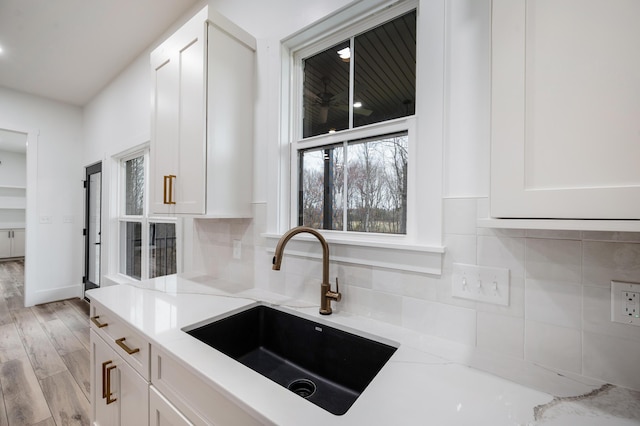1065 Cedar Fox Ct, Forest, VA 24551 - kitchen with a sink, light stone countertops, tasteful backsplash, and white cabinets