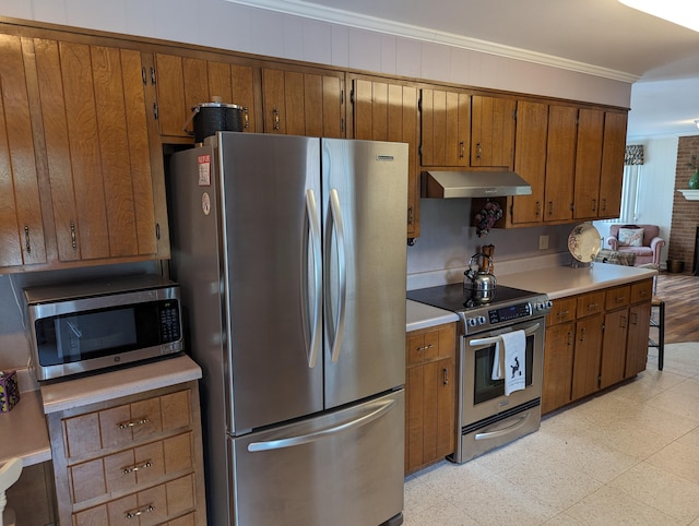 kitchen featuring under cabinet range hood, brown cabinetry, stainless steel appliances, and light floors