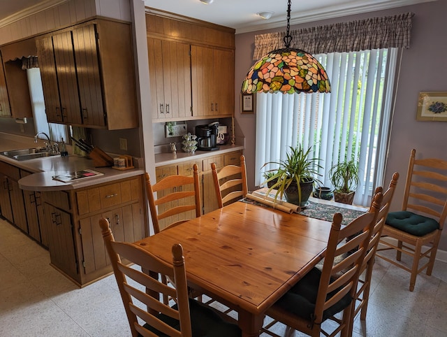 dining space with light floors and ornamental molding