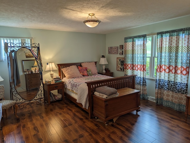 bedroom with a textured ceiling and wood-type flooring