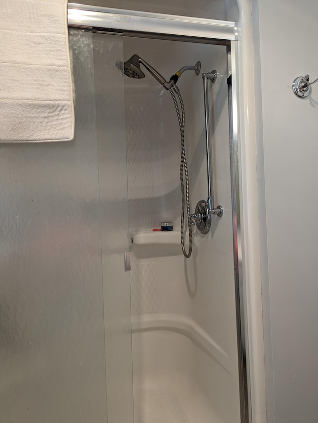 interior details featuring a stall shower