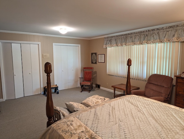 carpeted bedroom with ornamental molding, baseboards, multiple closets, and visible vents