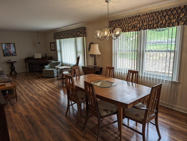 dining room featuring baseboards, dark wood-style flooring, an inviting chandelier, and crown molding