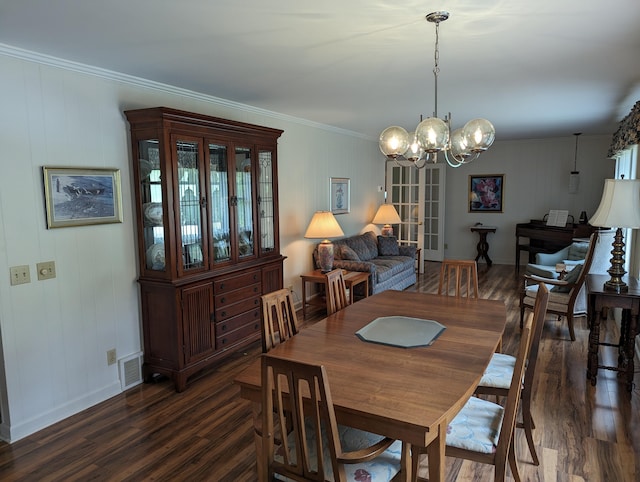 dining space featuring crown molding, visible vents, dark wood-style flooring, baseboards, and a chandelier