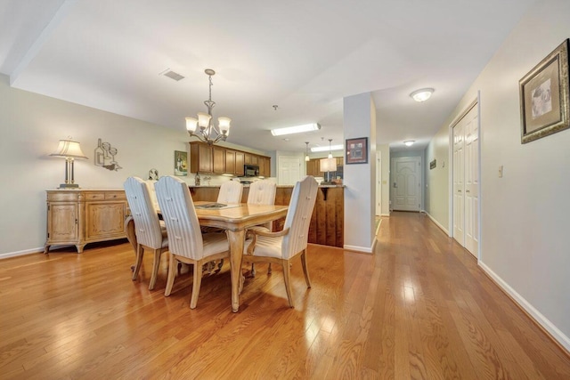 1100 Celebration Ave Unit 405, Moneta, VA 24121 - dining area featuring a chandelier, light wood finished floors, and baseboards