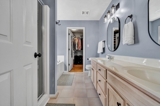 4848 Hickory Ridge Ct, Roanoke, VA 24018 - bathroom with a stall shower, double vanity, a walk in closet, tile patterned floors, and toilet