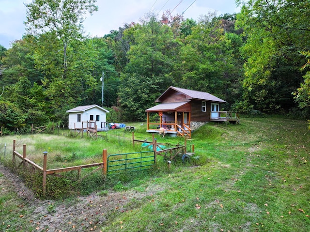 195 Lost Spring Ln, Lexington, VA 24450 - view of yard with fence, a forest view, an outdoor structure, and a deck