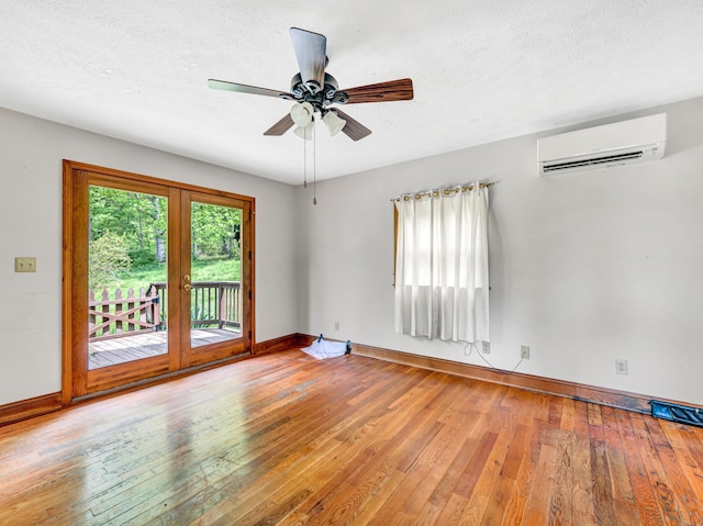 195 Lost Spring Ln, Lexington, VA 24450 - unfurnished room featuring a wall mounted air conditioner, wood-type flooring, baseboards, and french doors