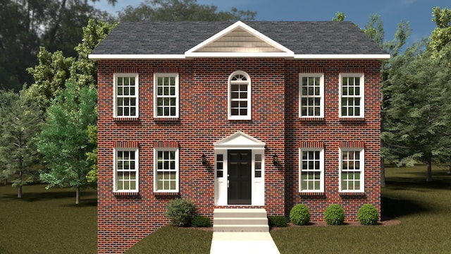 colonial inspired home featuring a front lawn and brick siding