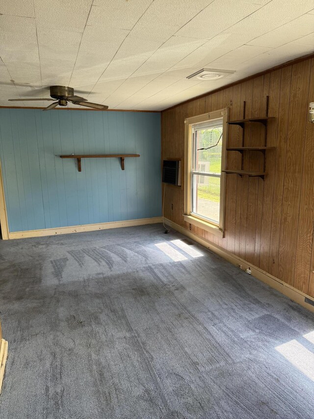 2807 S Carpenter Dr, Covington, VA 24426 - unfurnished living room featuring wood walls, baseboards, and carpet floors