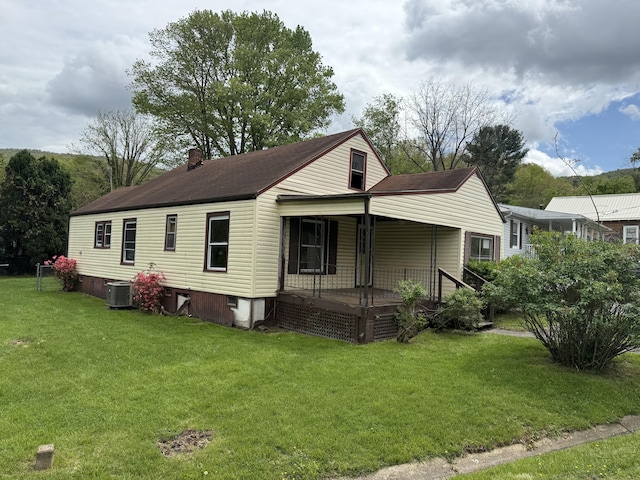 2807 S Carpenter Dr, Covington, VA 24426 - view of front facade with a porch, a front lawn, a chimney, and central AC unit