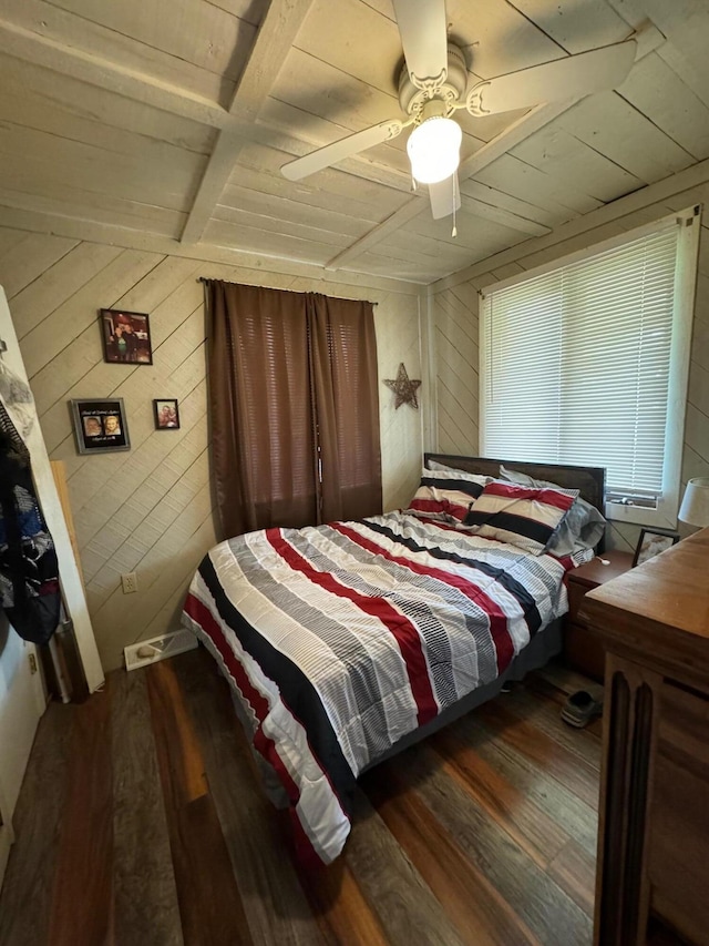 bedroom with wooden walls, wood ceiling, and wood finished floors