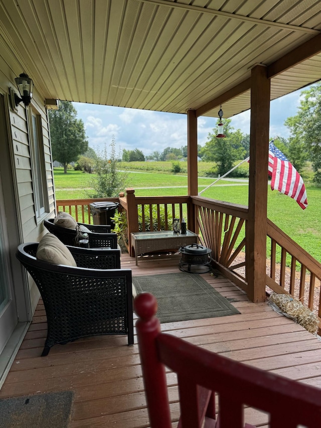 wooden terrace featuring a lawn