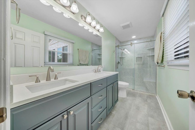 full bath with toilet, a shower stall, double vanity, baseboards, and tile patterned floors
