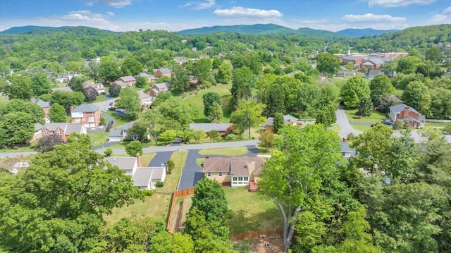 aerial view of property's location with mountains, nearby suburban area, and a forest