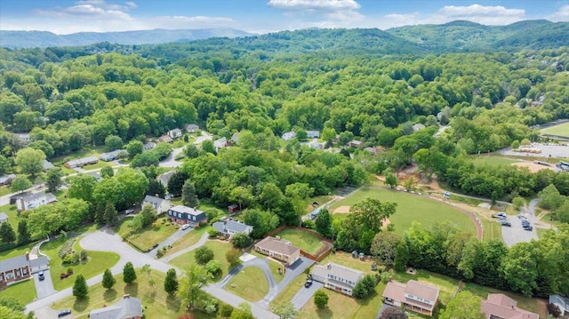 aerial view of a heavily wooded area and a mountainous background