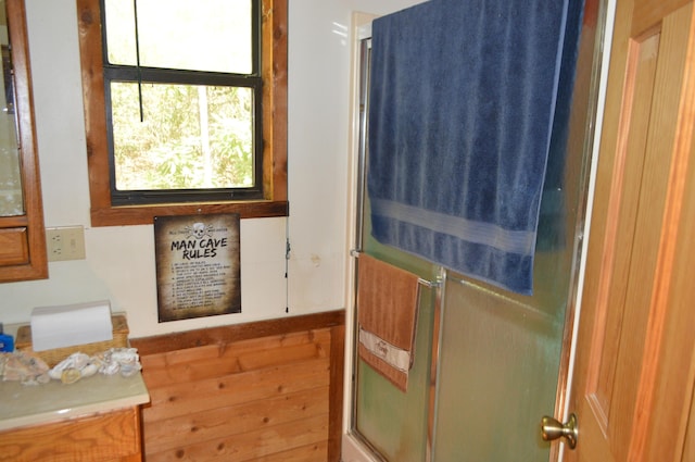 bathroom featuring a shower with door