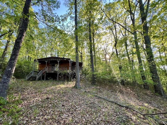 view of outbuilding featuring stairs and a forest view