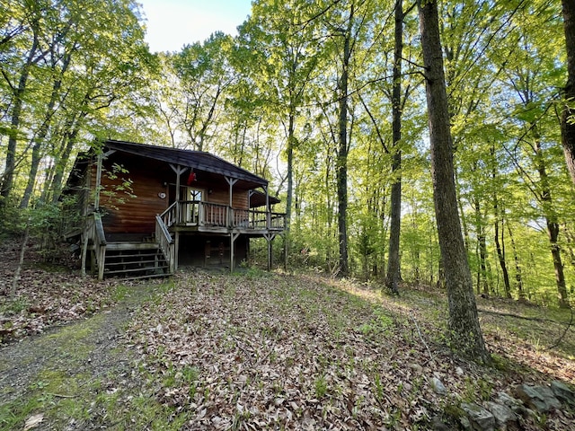 view of yard with a wooden deck and stairs