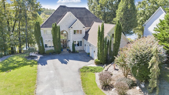 2580 Lakewood Forest Rd, Moneta, VA 24121 - french country home featuring stone siding, driveway, a front yard, and an attached garage
