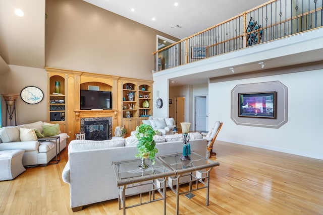 2580 Lakewood Forest Rd, Moneta, VA 24121 - living room featuring a high ceiling, a fireplace, wood finished floors, recessed lighting, and baseboards