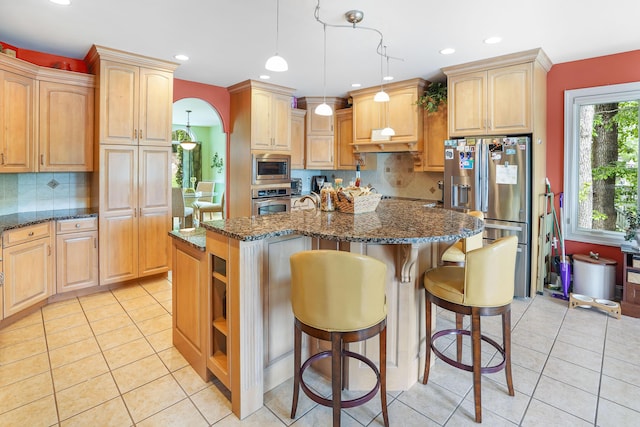 2580 Lakewood Forest Rd, Moneta, VA 24121 - kitchen with appliances with stainless steel finishes, dark stone countertops, light tile patterned flooring, an island with sink, and recessed lighting
