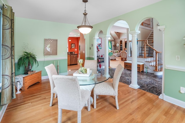 2580 Lakewood Forest Rd, Moneta, VA 24121 - dining room with decorative columns, light wood finished floors, arched walkways, and baseboards