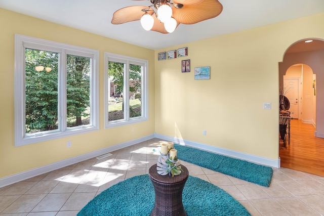2580 Lakewood Forest Rd, Moneta, VA 24121 - tiled empty room featuring arched walkways, a ceiling fan, and baseboards