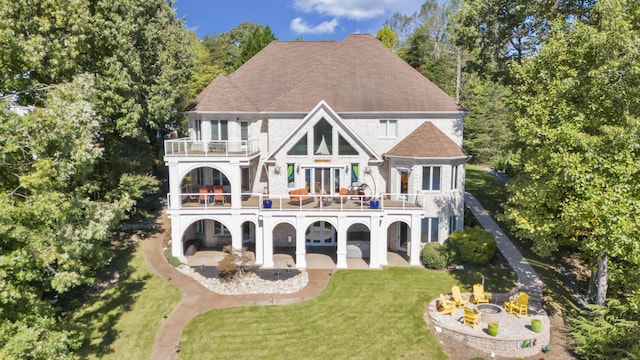 2580 Lakewood Forest Rd, Moneta, VA 24121 - back of property with a balcony, french doors, a patio, a lawn, and a fire pit