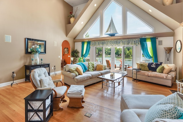 2580 Lakewood Forest Rd, Moneta, VA 24121 - living area with high vaulted ceiling, arched walkways, wood finished floors, and baseboards