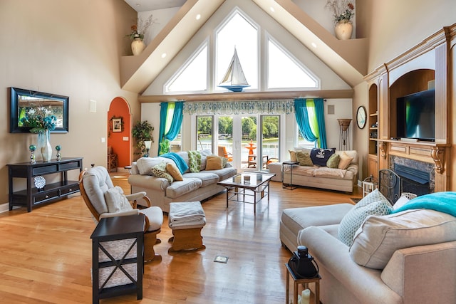 2580 Lakewood Forest Rd, Moneta, VA 24121 - living room featuring a towering ceiling, a fireplace, light wood-type flooring, arched walkways, and recessed lighting