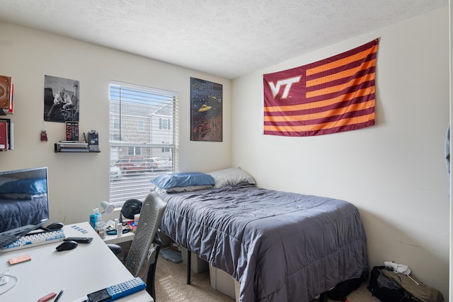 bedroom with carpet and a textured ceiling