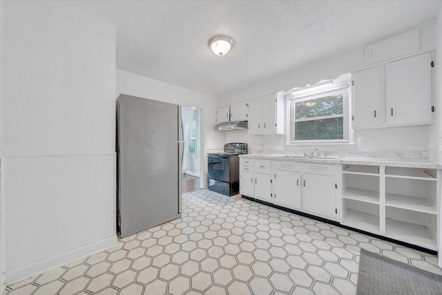 1218 Grayson Ave NW, Roanoke, VA 24017 - kitchen with black range with electric stovetop, under cabinet range hood, a sink, white cabinets, and a textured ceiling