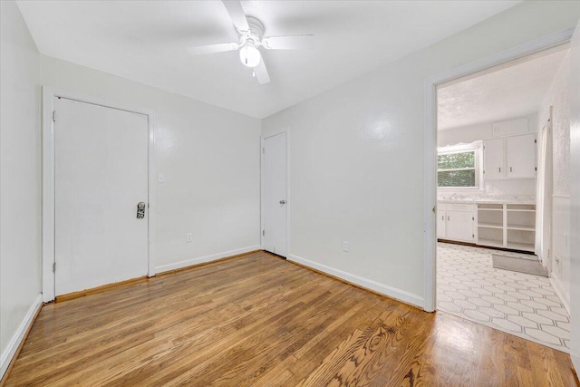 1218 Grayson Ave NW, Roanoke, VA 24017 - unfurnished bedroom with light wood-style flooring, baseboards, and a ceiling fan