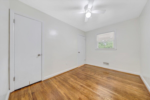 1218 Grayson Ave NW, Roanoke, VA 24017 - unfurnished bedroom with wood finished floors, baseboards, and a ceiling fan