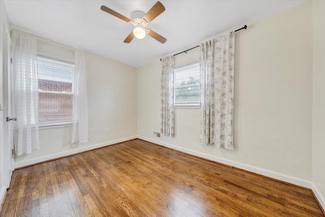 1218 Grayson Ave NW, Roanoke, VA 24017 - empty room featuring wood finished floors, baseboards, and a ceiling fan