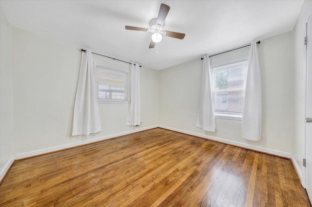 1218 Grayson Ave NW, Roanoke, VA 24017 - unfurnished room with wood finished floors, a ceiling fan, and baseboards