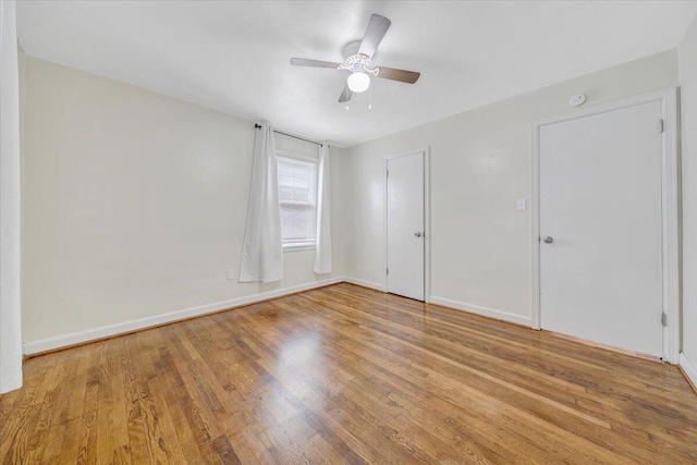 1218 Grayson Ave NW, Roanoke, VA 24017 - unfurnished bedroom featuring light wood finished floors, baseboards, and a ceiling fan