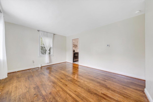 1218 Grayson Ave NW, Roanoke, VA 24017 - spare room with wood finished floors, a smoke detector, and baseboards