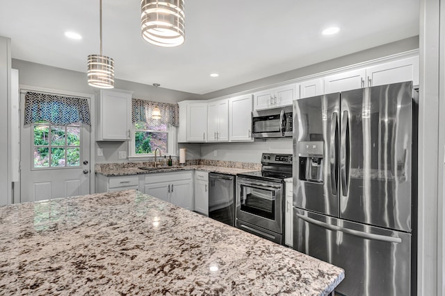 3443 Overhill Trl, Roanoke, VA 24018 - kitchen featuring stainless steel appliances, a sink, light stone countertops, white cabinetry, and pendant lighting
