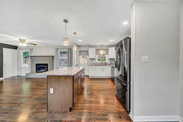 3443 Overhill Trl, Roanoke, VA 24018 - kitchen featuring freestanding refrigerator, a sink, open floor plan, a center island, and white cabinetry