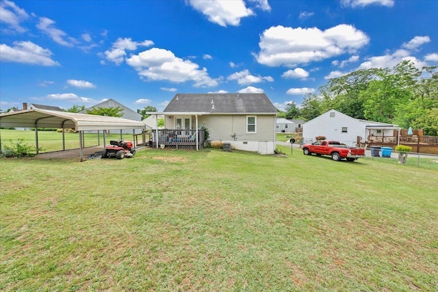 back of house with a detached carport