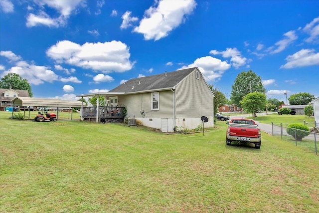 back of property featuring a detached carport and central AC