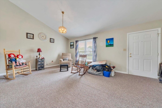 living area with carpet floors, baseboards, vaulted ceiling, and a chandelier