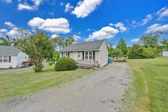 bungalow-style house featuring a carport, asphalt driveway, and a front yard